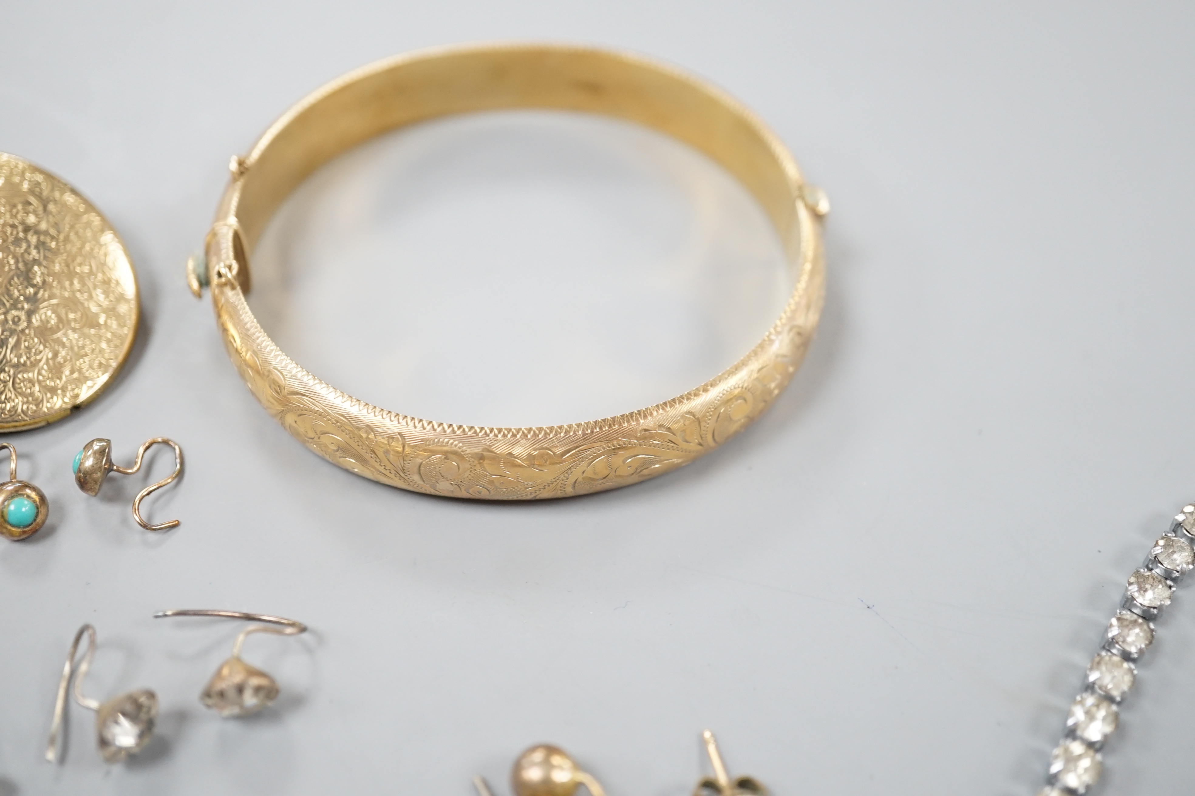 A 9ct gold hinged bangle, 17.4 grams, an engraved yellow metal locket, a 9ct and gem set bar brooch, gross 3.3 grams, a Victorian yellow metal and turquoise set small mourning brooch, one other brooch, assorted earrings